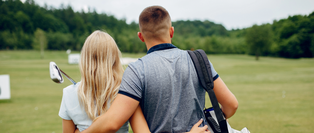 CoEd golf players having fun riding around in a cart